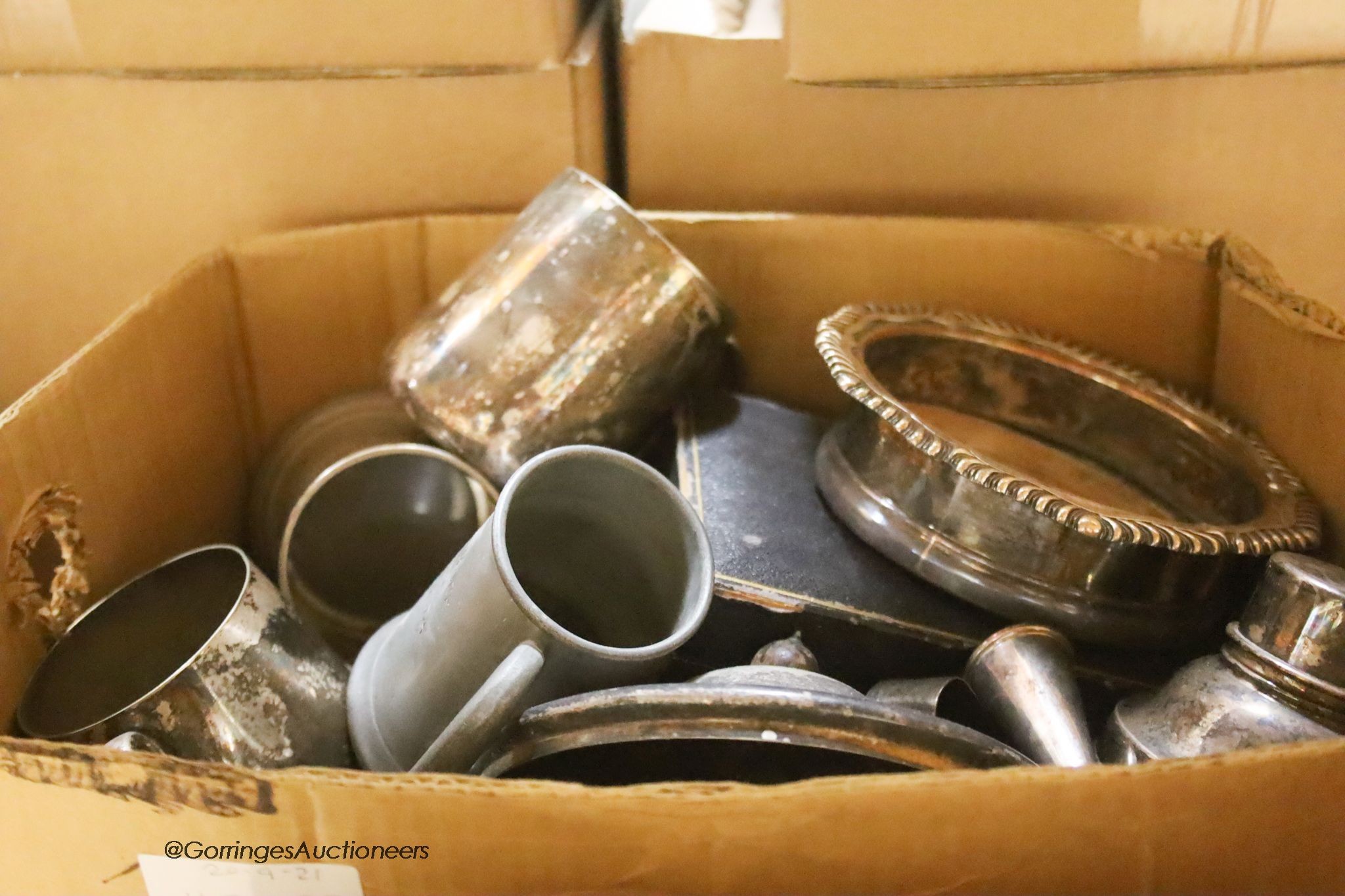 Two boxes of assorted 19th century and late plated wares including an oval box, a pair of wine coasters and assorted flatware.